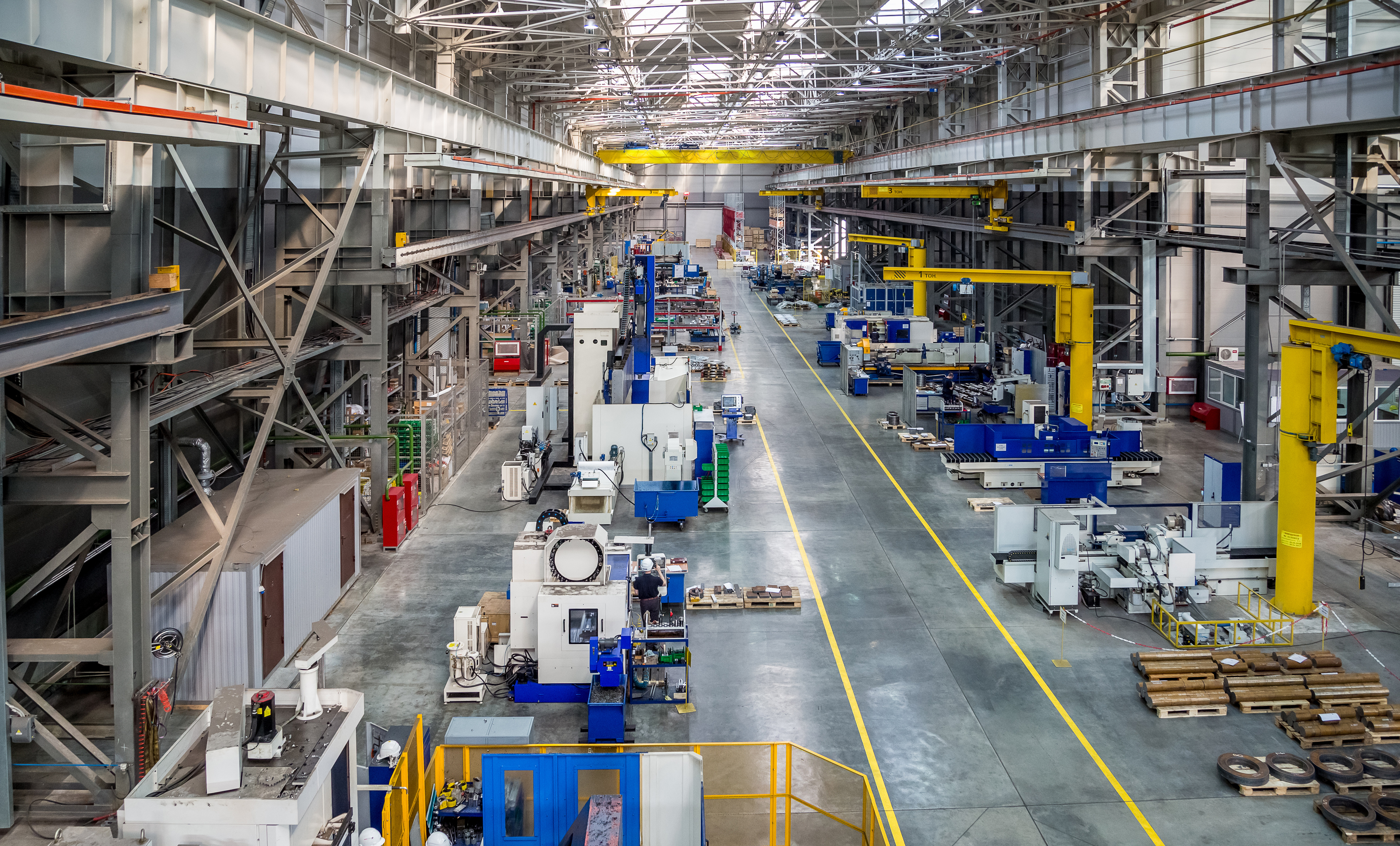 Industrial production facility with machinery and overhead cranes
