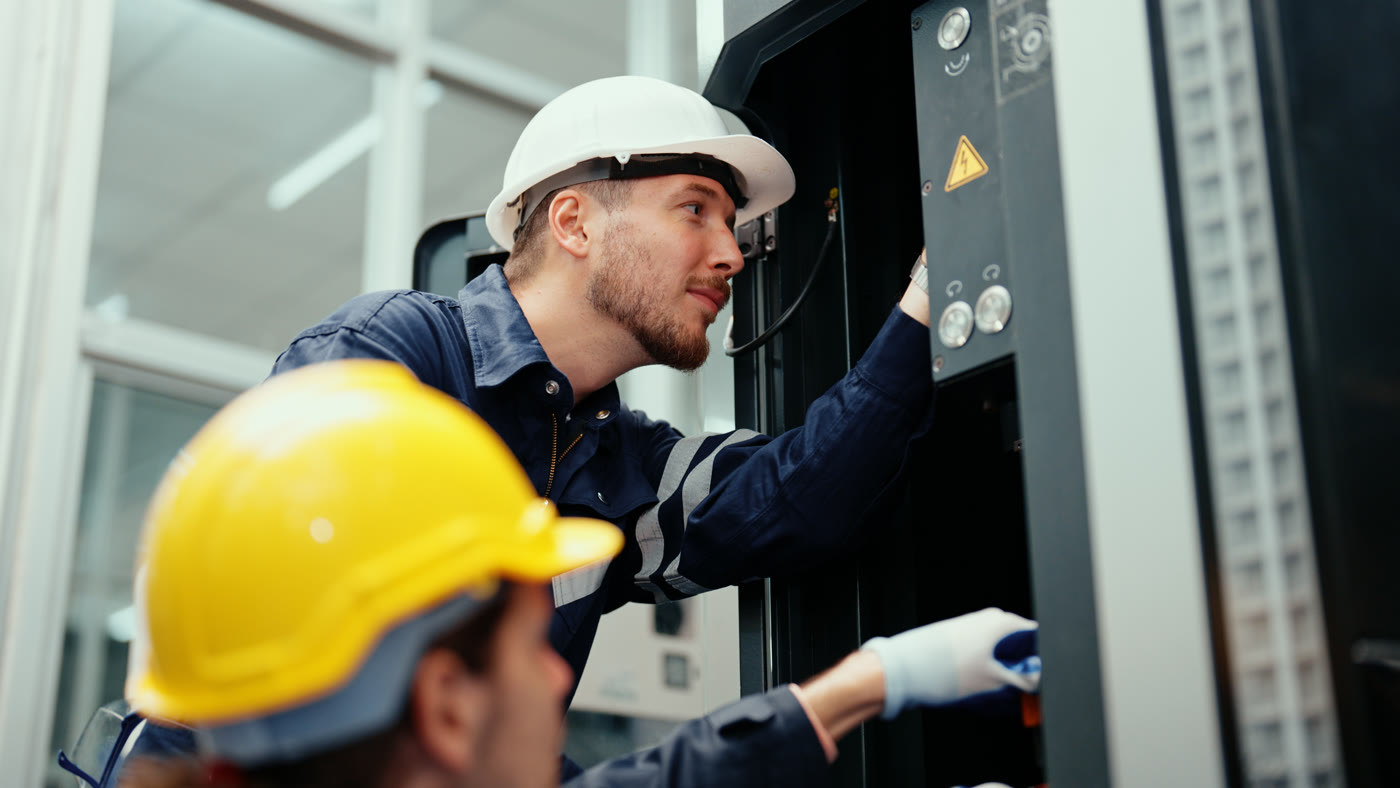 Technicians inspecting industrial machinery